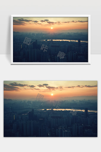 夕阳映照下的现代都市高楼与远山景色